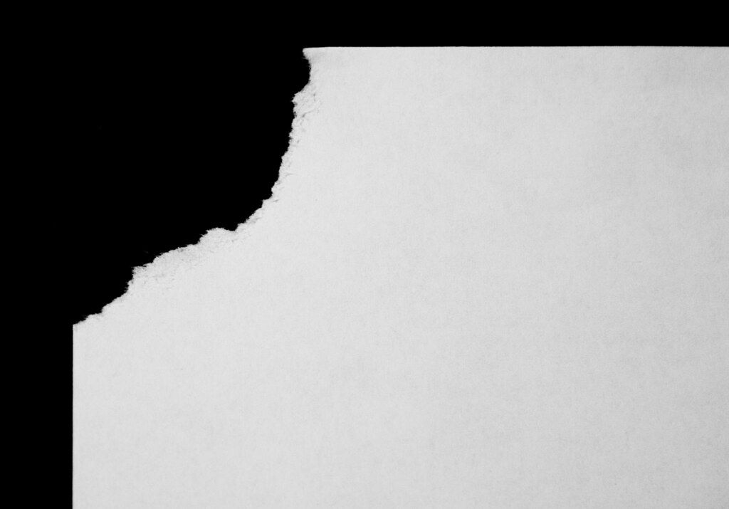 A close-up of cream paper with a lightly textured surface.